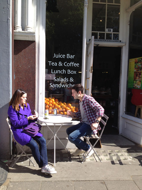 Couple having breakfast outside a Juice bar